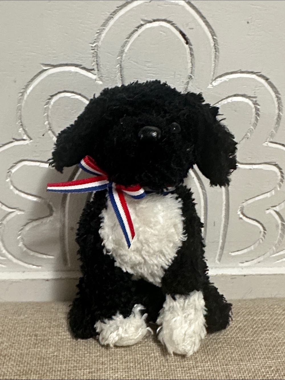 Black & White Plush Dog Toy with Red-White-Blue Ribbon